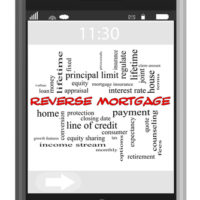 Phone that reads reverse mortgage Phone that reads reverse mortgage